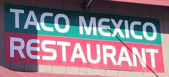 The Taco Mexico Restaurant sign: a dark green band reading TACO MEXICO over a red band reading RESTAURANT